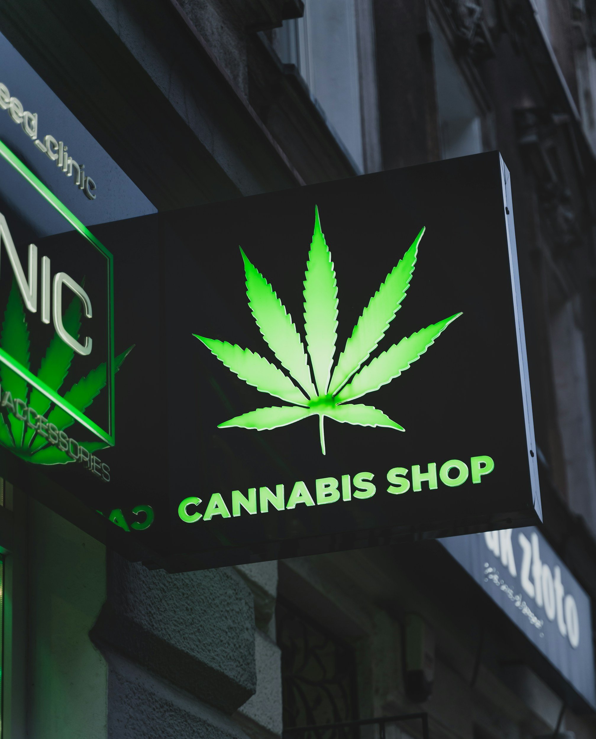Dispensary storefront with illuminated cannabis sign